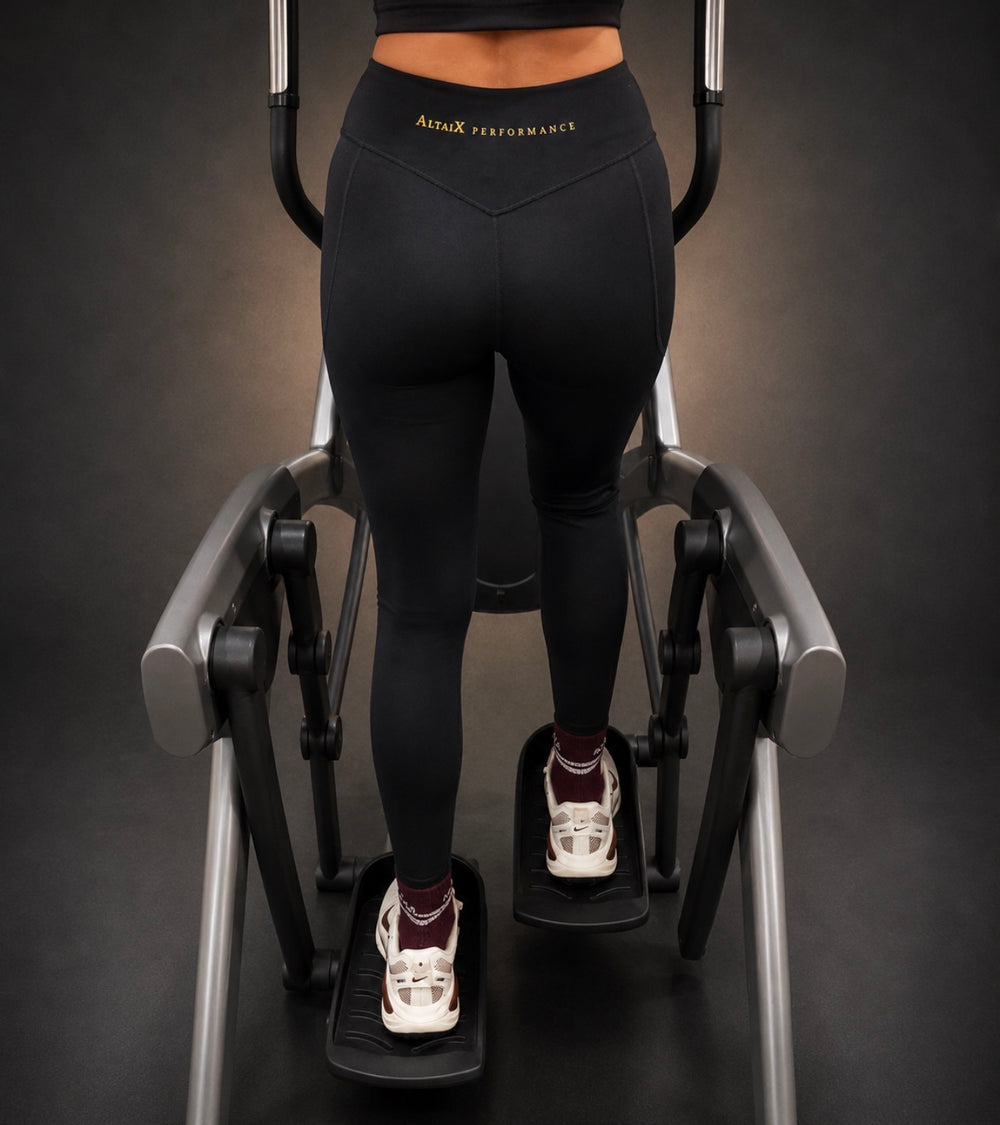 AltaiX First Edition Women's High-Waisted Black Leggings with supportive compression, four-way stretch, signature gold branding and a sculpting fit for gym training, HYROX, running and everyday wear.
