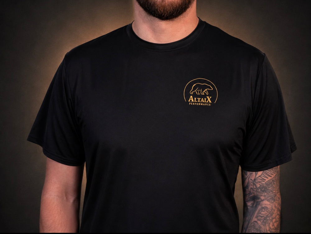 AltaiX First Edition Men's Performance T-Shirt in Black with lightweight breathable four-way stretch fabric, a relaxed athletic fit and signature gold branding for gym training, HYROX, strength training and everyday wear.