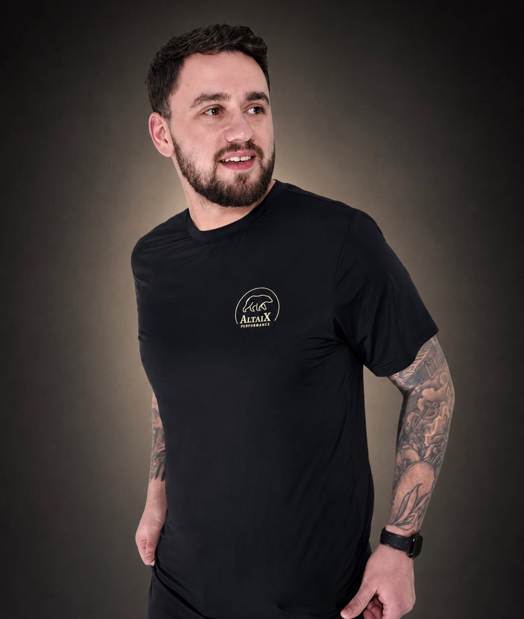 AltaiX First Edition Men's Performance T-Shirt in Black with lightweight breathable four-way stretch fabric, a relaxed athletic fit and signature gold branding for gym training, HYROX, strength training and everyday wear.